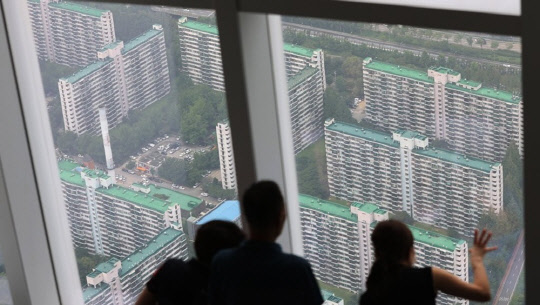 시민들이 서울 송파구 롯데월드타워 전망대 서울스카이에서 송파구 잠실주공5단지를 바라보고 있다.<연합뉴스>